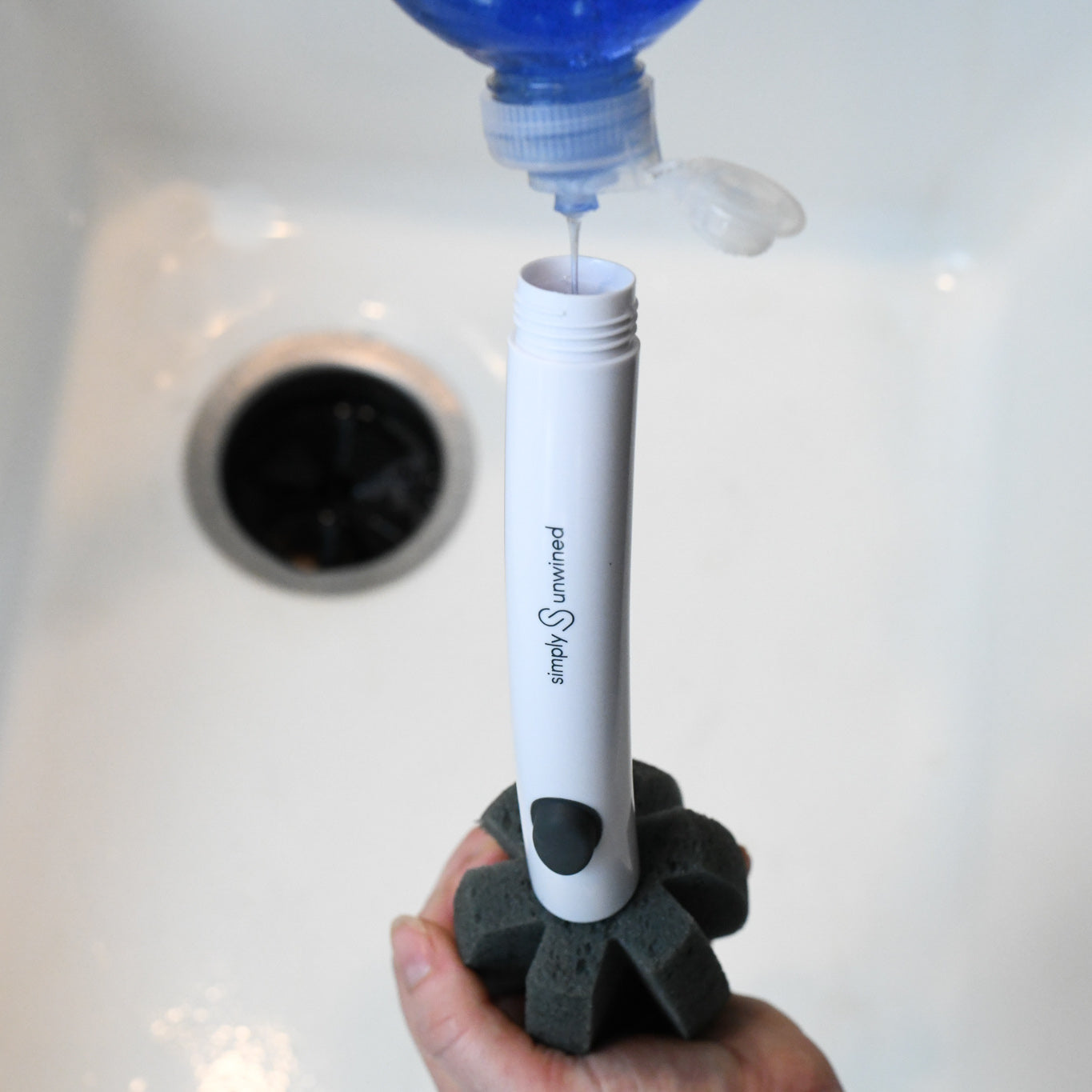 The WINE Brush is a soap dispensing glassware cleaning brush